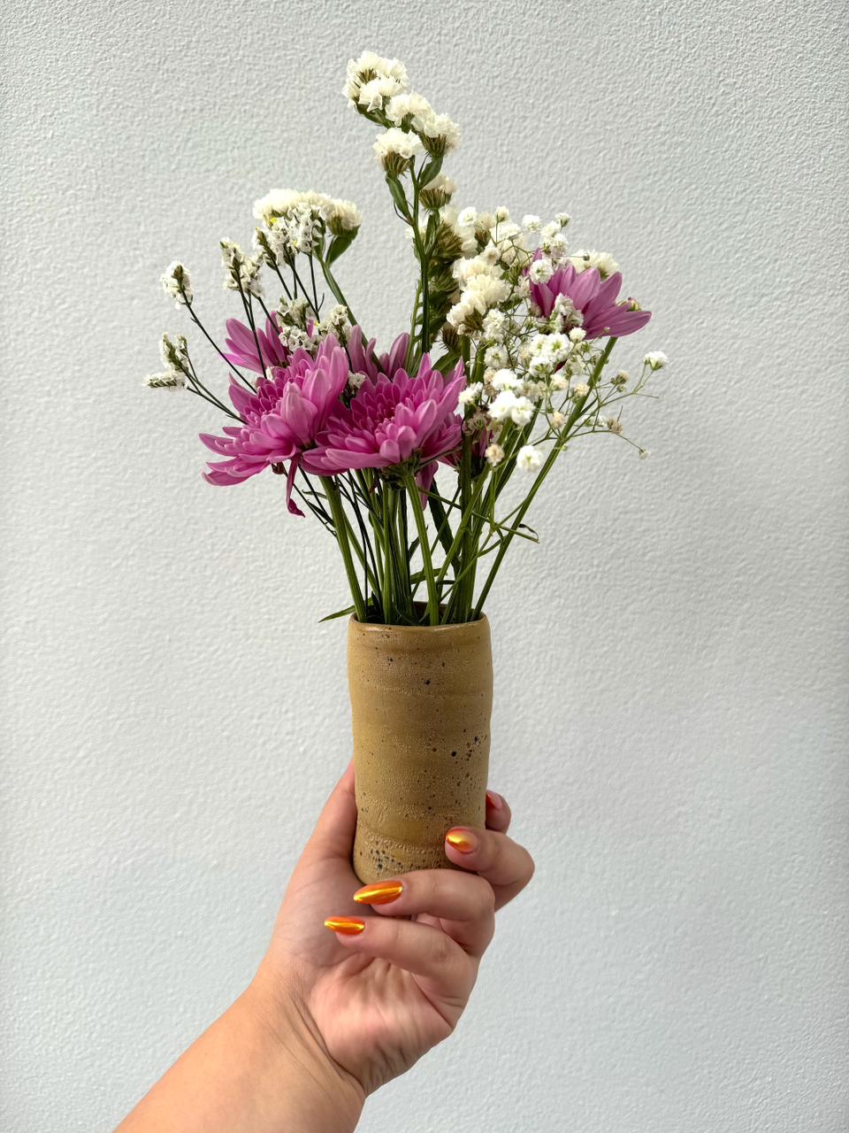 Beige hands on vase